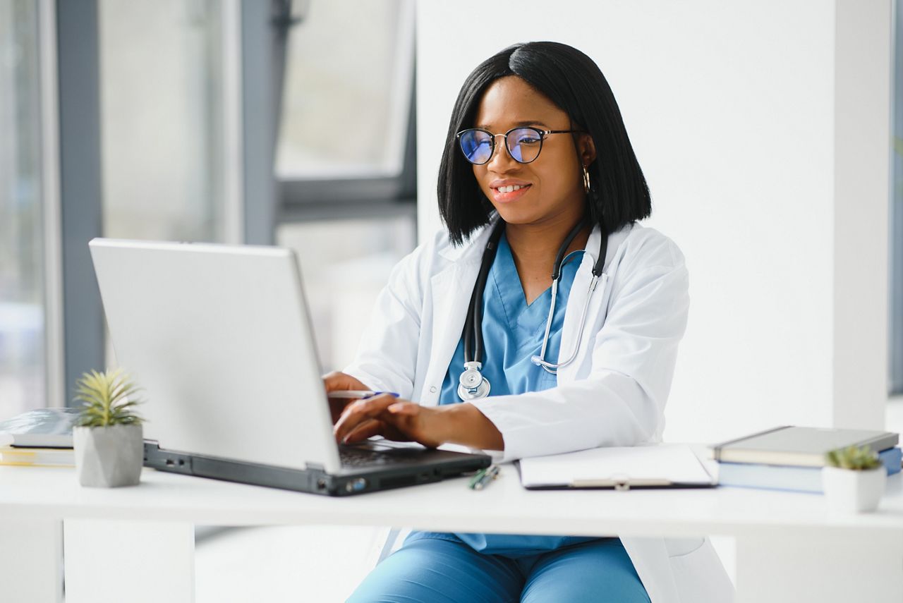 African American doctor working in her office at clinic