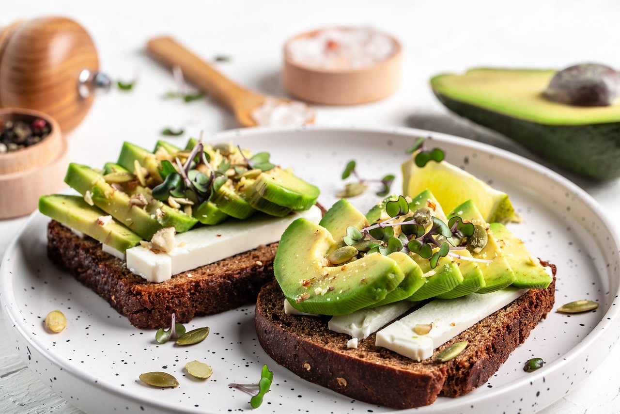 Healthy toasts with avocado cheese and whole wheat rye bread 