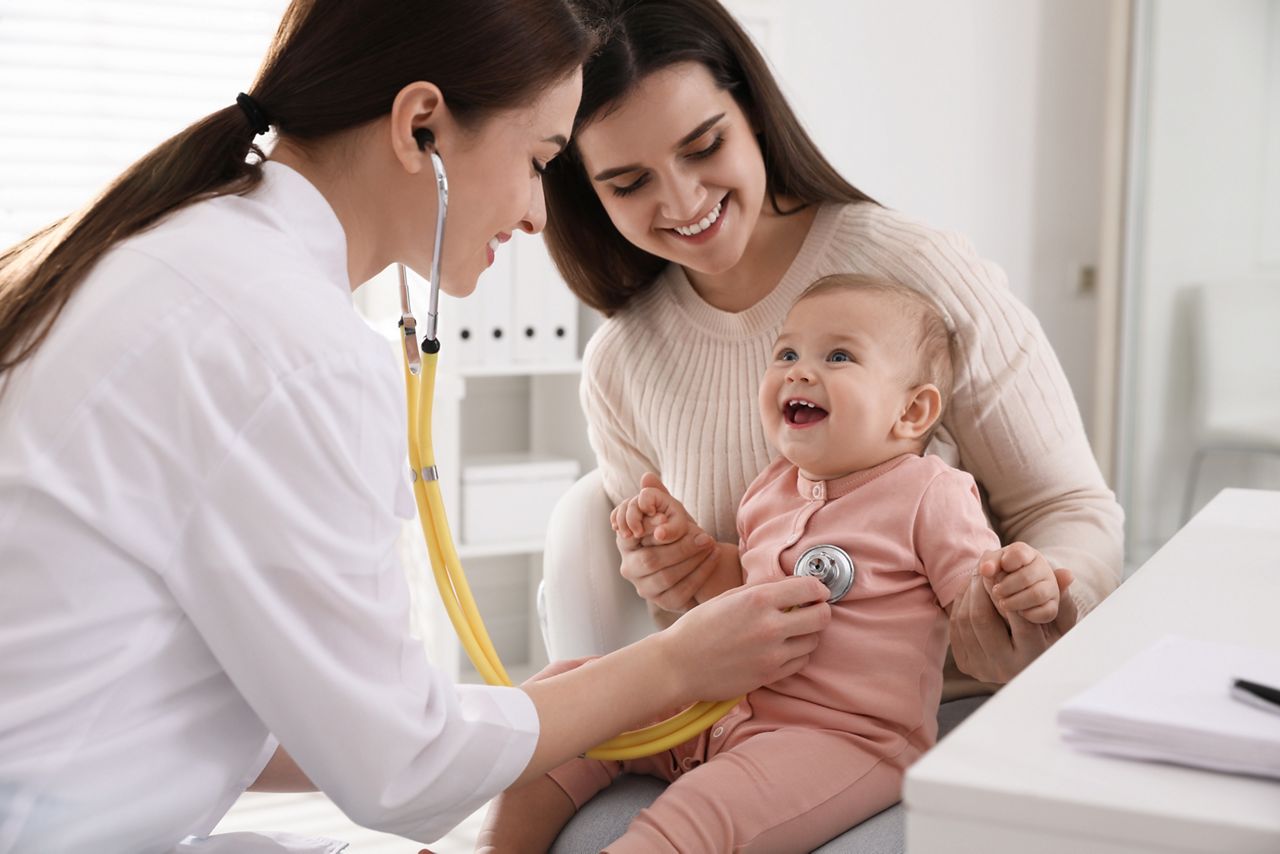 Mother with her cute baby visiting pediatrician in clinic