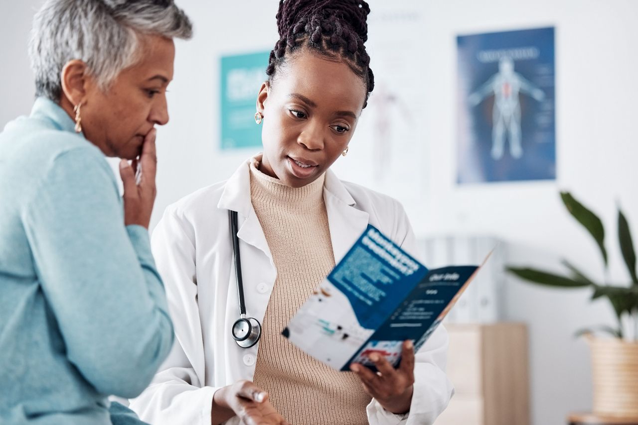 Brochure, consulting or doctor talking to patient for life insurance or healthcare services or medical data. Medicine, nurse helping or mature woman learning info on pamphlet in hospital for advice.