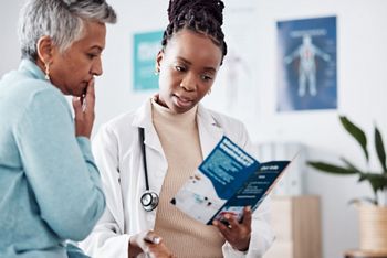 Brochure, consulting or doctor talking to patient for life insurance or healthcare services or medical data. Medicine, nurse helping or mature woman learning info on pamphlet in hospital for advice.