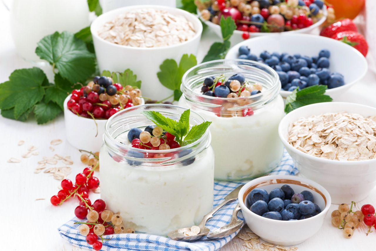 yogurt with berries and products for healthy breakfast, close-up