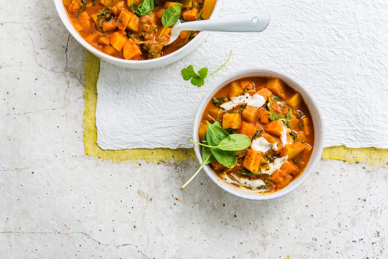 CE7049A0-E07F-4FFA-B4496E42D5001BDF<br>A_NA_NA_Master_Recipe_Image_vegetablestew___GreekStyle_NA_Soy_NA_Pot_400g_HR_horizontal.tif<br>Vegetable Stew

Warm up with this wholesome, hearty stew made with Alpro Plain Soya alternative to Greek Style yogurt

"220g Alpro Plain Soya alternative to Greek Style yogurt
600ml water
900g vegetables: potato, pumpkin and sweet potato
200g spinach
2 onions
2 garlic cloves
4cm ginger, grated
½ red chilli pepper (optional)
500ml tomato passata
1 ½ tbsp garam masala or ras el hanout
1 tbsp curry powder
1 tsp turmeric
1 lime, juice
Fresh coriander
2 tbsp olive oil or coconut oil
Salt & pepper"

"1.	First peel the veggies and cut into equal sized chunks. Finely chop the onion and chilli; grate the ginger and crush the garlic.
2.	Next, heat the oil and fry onion, garlic, ginger and chilli until the onions are translucent. Add the spices and cook for 1-2 minutes, stir-frying to release all the wonderful aromas. Add all the veggies (except the spinach), tomato passata, water and coriander.
3.	Let it simmer for 20-30 minutes on a low heat, stirring frequently until the potatoes are soft. Now add the spinach and Alpro Plain Soya alternative to Greek Style yogurt and simmer for a further 2 minutes just to wilt the spinach.
4.	Season with salt and a little lime juice. Serve steaming hot, sprinkled with a few extra fresh coriander leaves if you like. A super-sustaining, one pot meal in a bowl!"