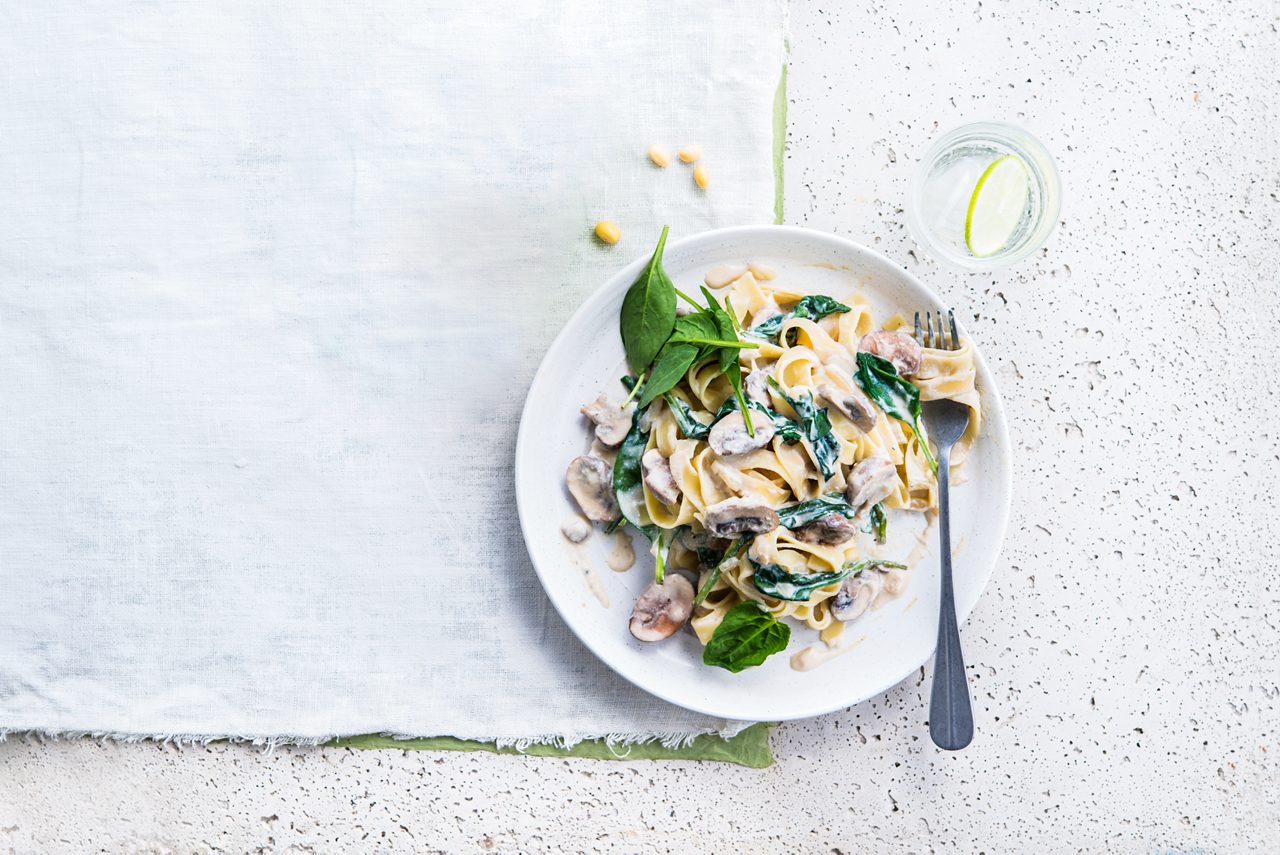 3C591269-63AC-479C-B7D114872AA634BC<br>A_NA_NA_Master_Recipe_Image_pastaspinachmushroom___GreekStyle_NA_Soy_NA_Pot_400g_HR_horizontal.tif<br>Mushroom & Spinach Tagliatelle
Mama mia! Perfect pasta with Alpro Plain Soya alternative to Greek Style yogurt

"375g tagliatelle pasta
400ml Alpro Plain Soya alternative to Greek Style yogurt
1 large white onion, finely chopped
2  Portobello mushrooms or Paris mushrooms, sliced
250g of fresh spinach
1 cube vegetable stock 
1 tbsp olive oil
Ground pepper & salt"

"1. Quick, simple, 100% plant-based. In a large pan, add half of the vegetable stock cube to boiling water. Throw in the pasta and cook ‘al dente’, drain but keep the water. 
2. Meanwhile fry the onion and mushrooms, season with pepper and salt. 
3. Add the Alpro Plain Soya alternative to Greek Style yogurt, 300ml of the boiled water from the pasta and the other half of the vegetable stock cube. Stir until creamy, then add the spinach. That’s sauce sorted!
4. As soon as the spinach has wilted, stir in the cooked pasta and add more pepper and salt to taste. Serve with a little extra spinach if you like. Buon Appetito!  "