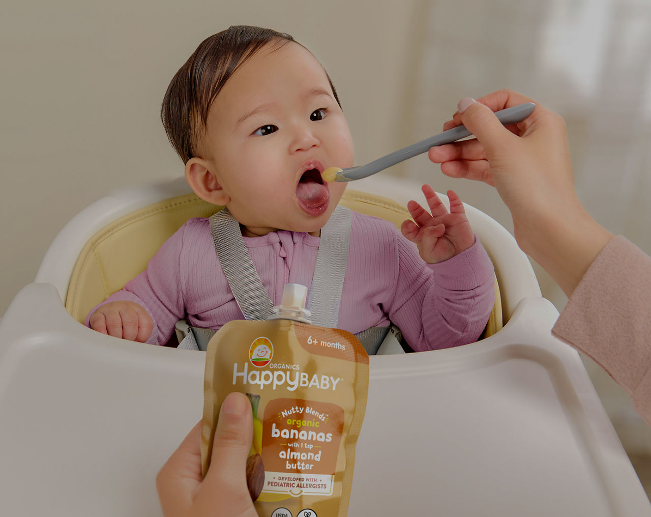 Baby being feed with happy baby pouch