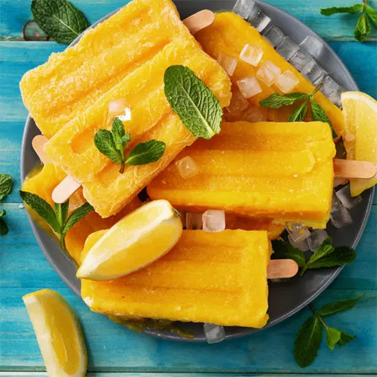 Refreshing mango popsicles with mint garnish
