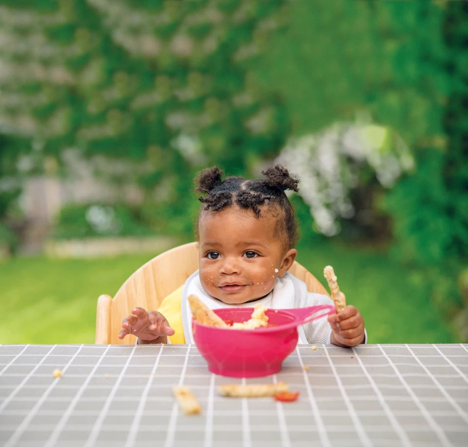 Baby eating breadsticks