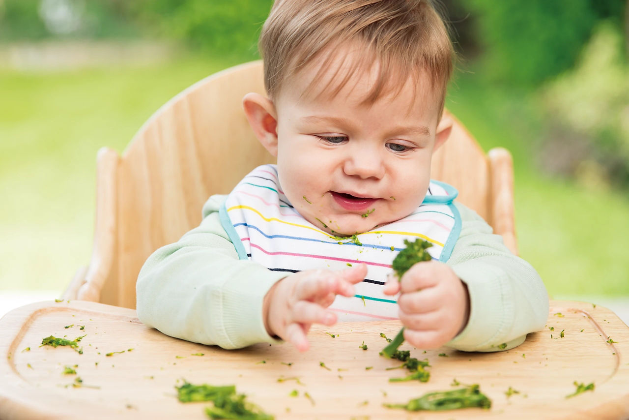 Baby eating outside