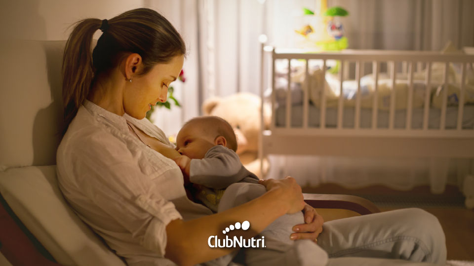 Madre amamantando a su bebé por la noche