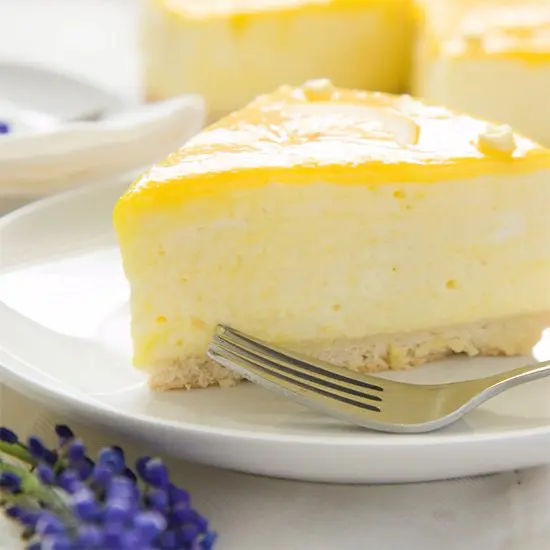 Slice of creamy lemon cheesecake on plate