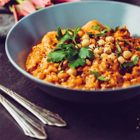Bowl of chickpea curry with garnish