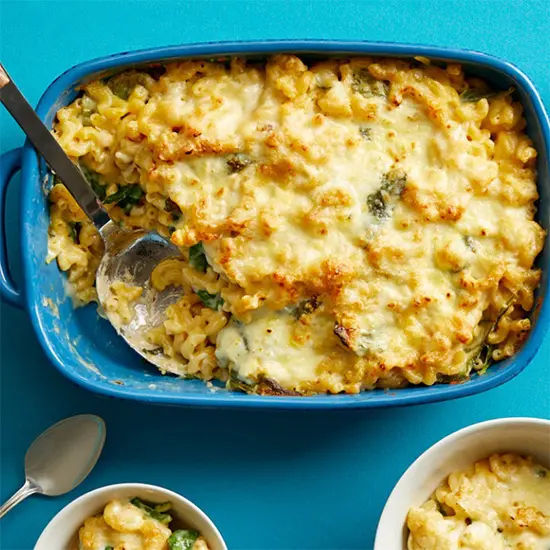 Cheesy baked pasta in blue casserole dish