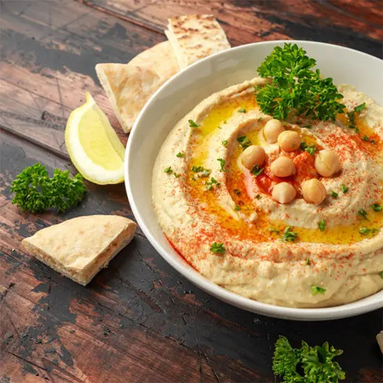 Fresh hummus with pita and garnish