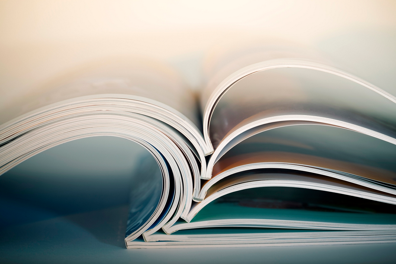 Abstract shot of open magazines stackon table. Macro shot with shallow DOF