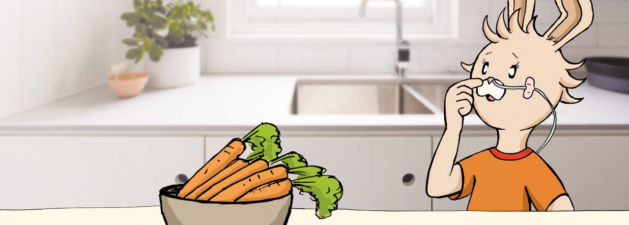 Ein gezeichneter Hase mit Ernährungssonde sitzt in einer Küche, vor ihm steht eine Schale mit frischen Karotten.