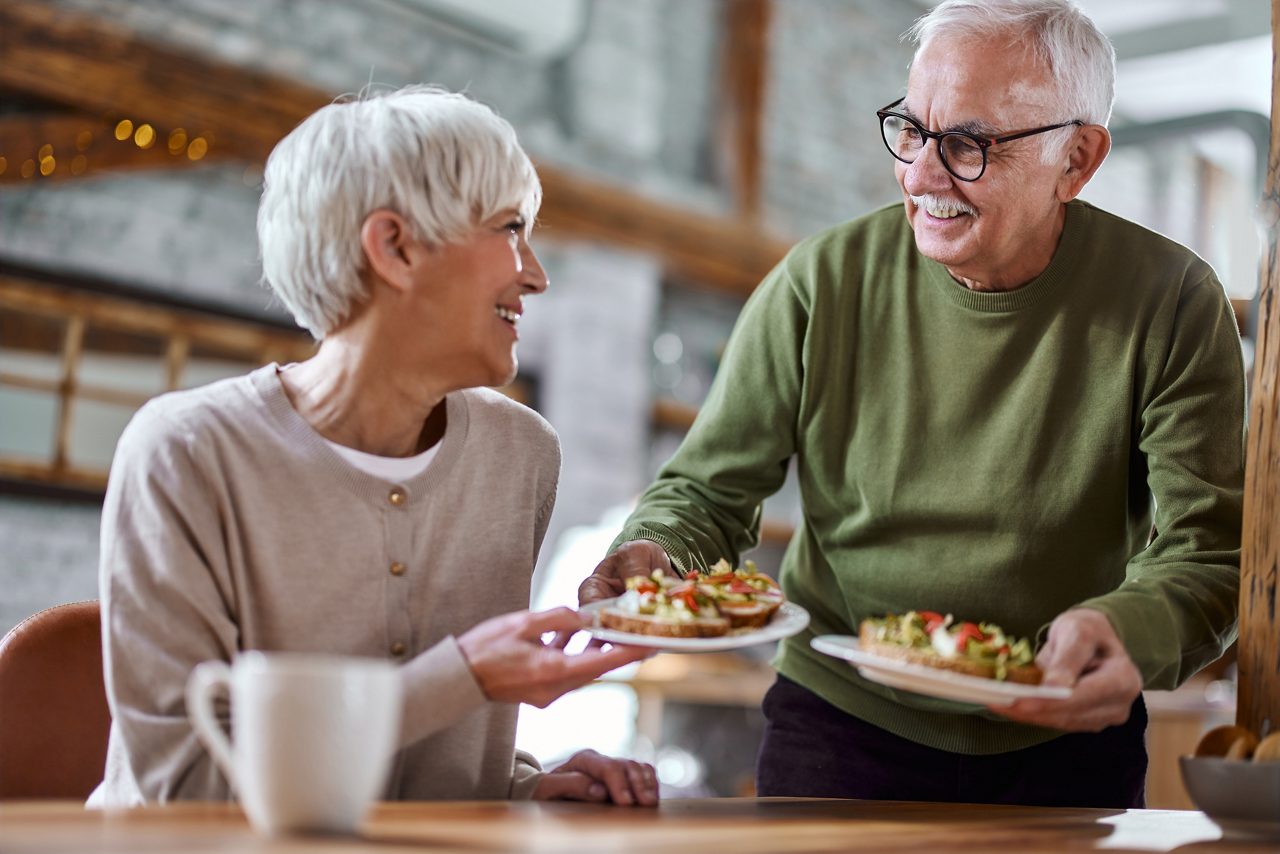 Mann kocht Essen für seine Frau, die eine Magen-Darm-Erkrankung hat