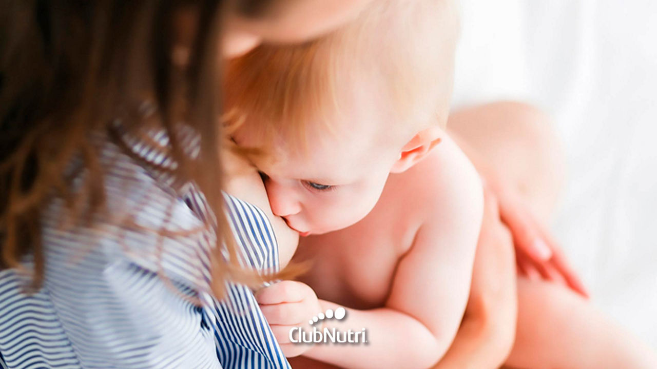 Breastfeeding baby on bed