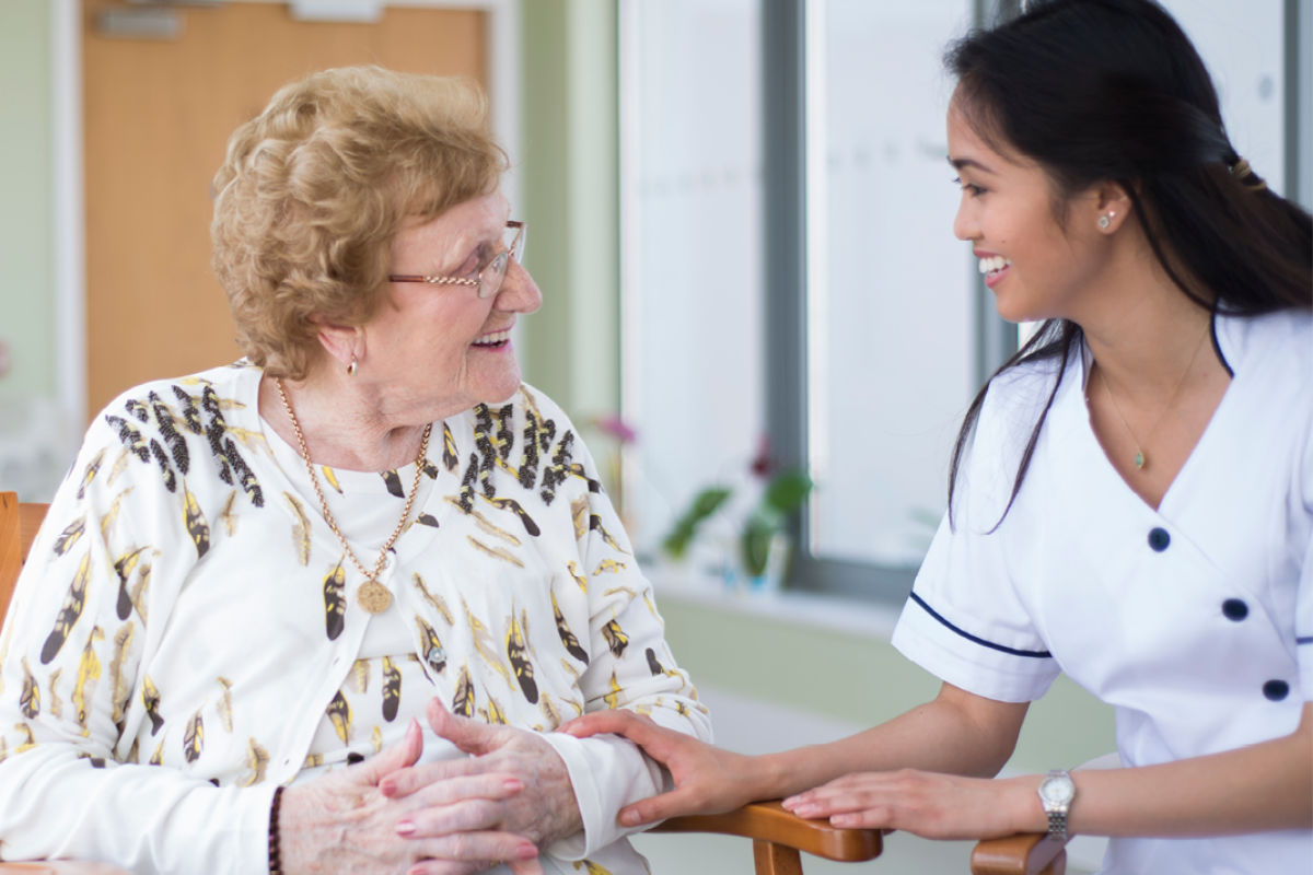 Nurse talking to elderly woman