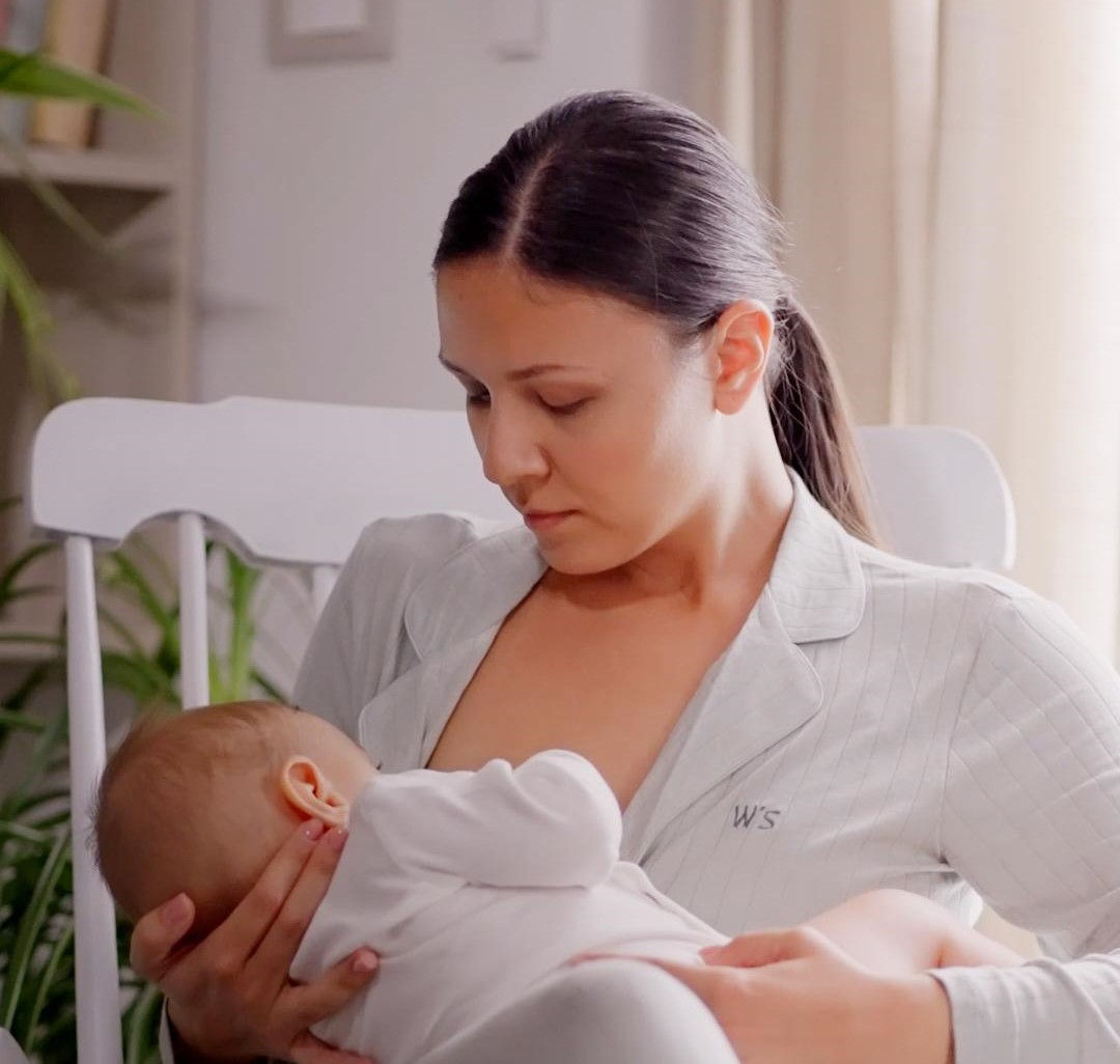 baby touching mother during breastfeeding 2
