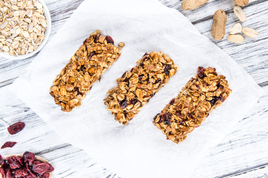 Homemade Granola Bars with Peanuts and Cranberries (selective focus) as detailed close-up shot