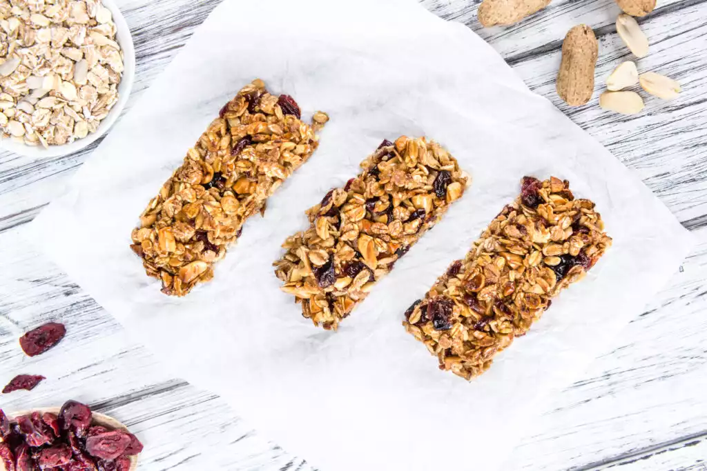 Homemade Granola Bars with Peanuts and Cranberries (selective focus) as detailed close-up shot