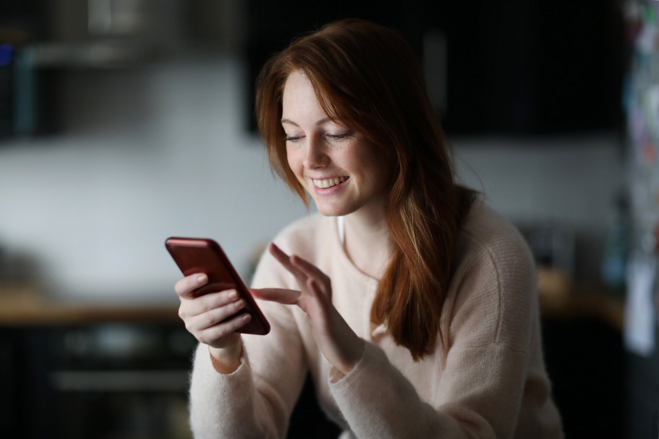 Portrait of a young redhead woman at home