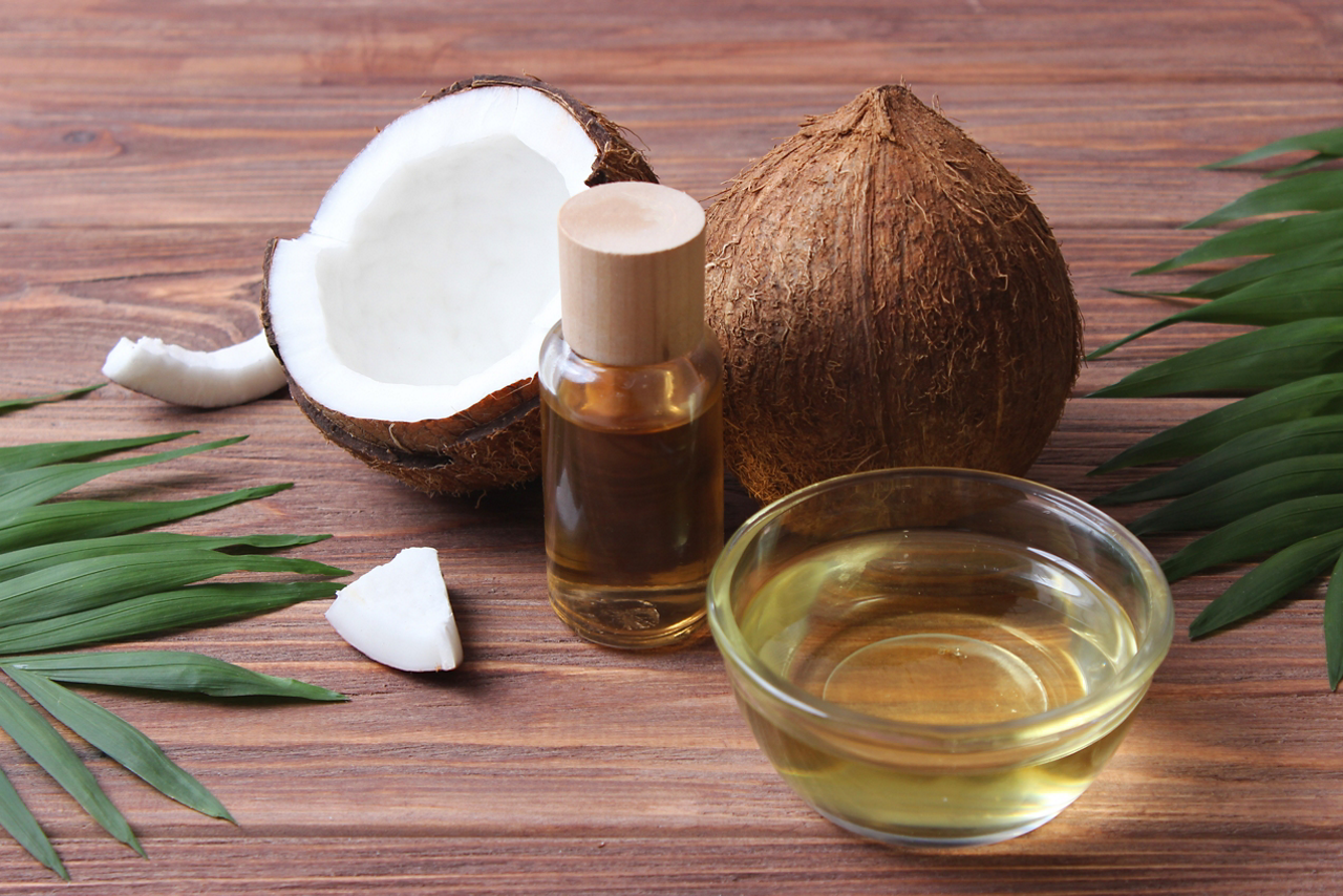 coconut oil and coconuts, palm branches close up. High quality photo