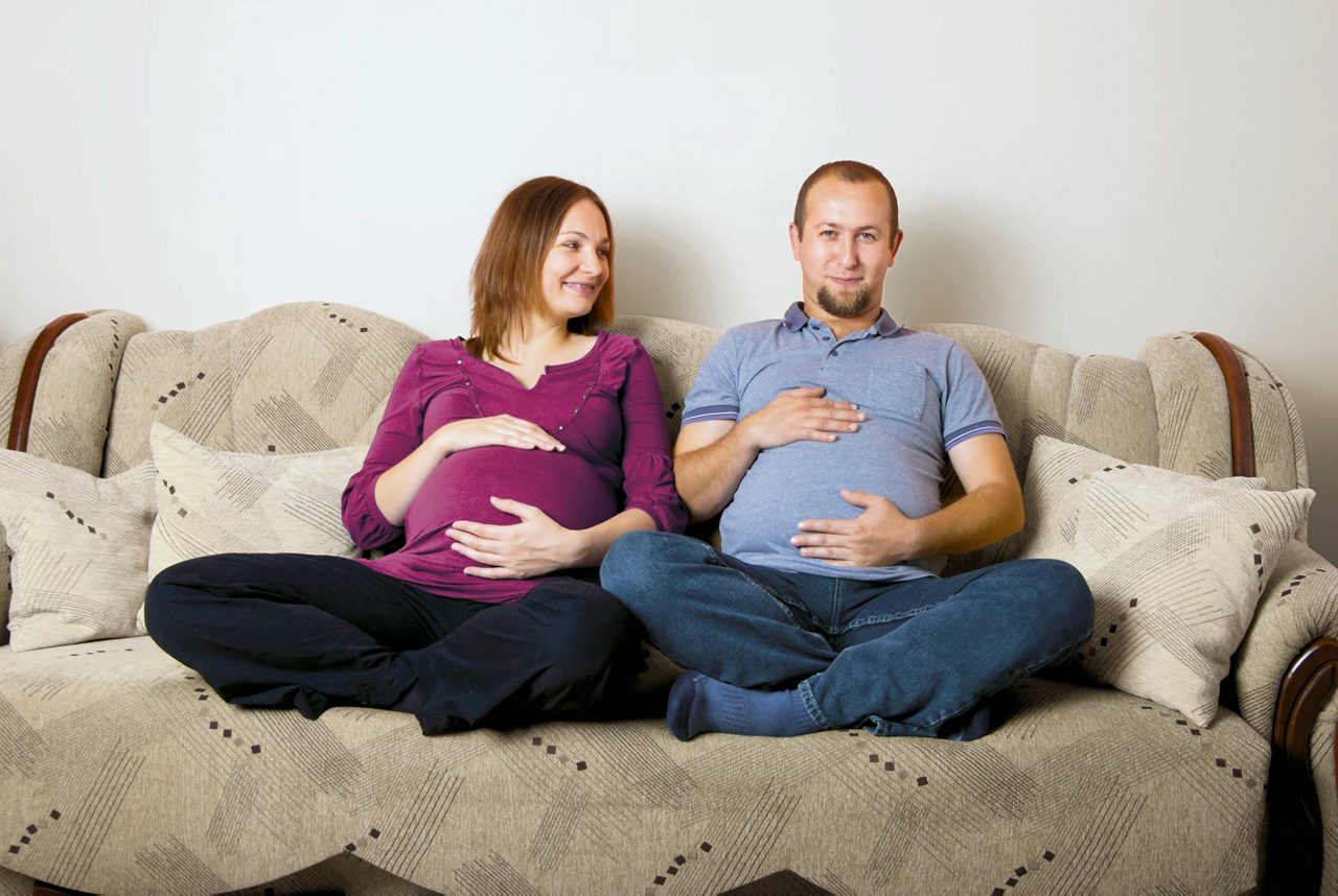 Pregnant woman having breakfast in bed