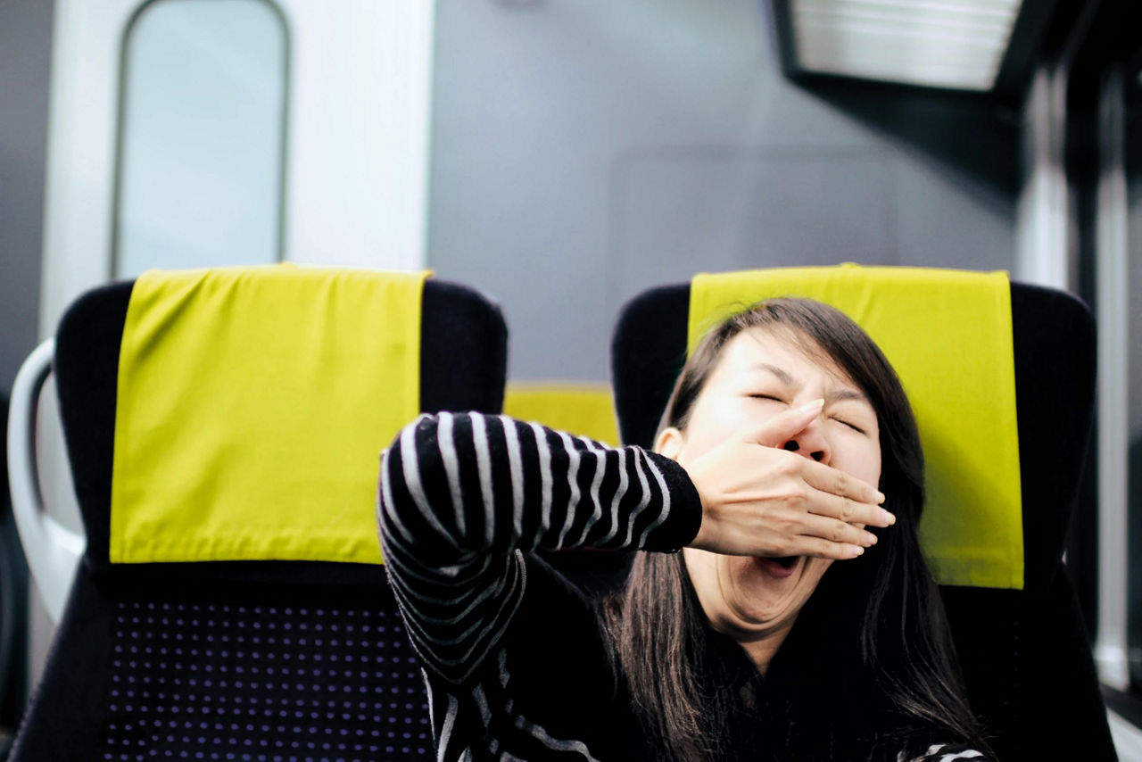 Yawning woman on a train