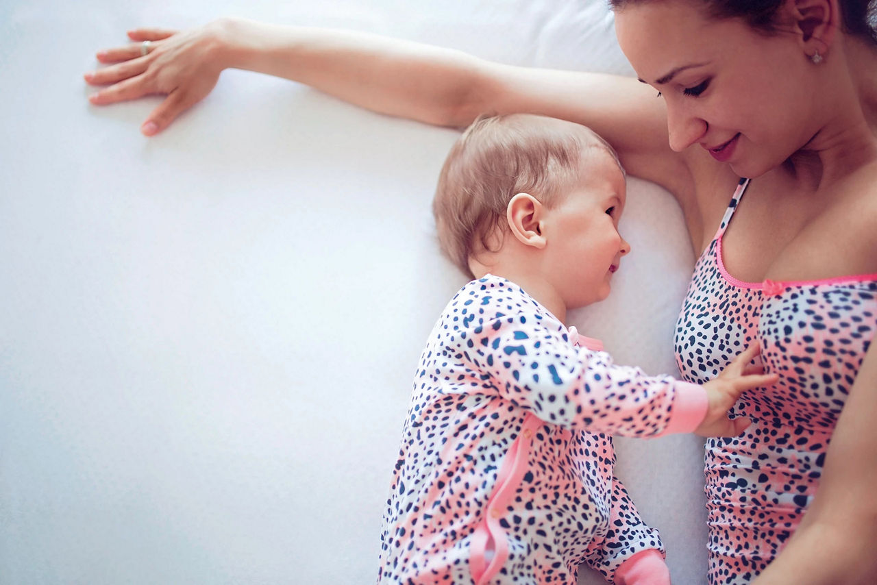 Baby laying with mom