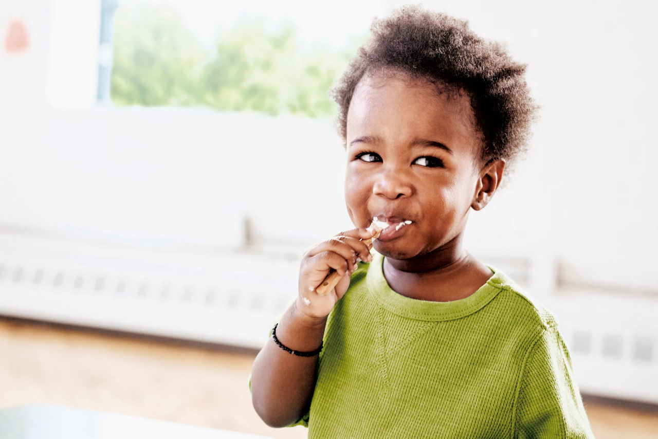 Toddler eating with fork