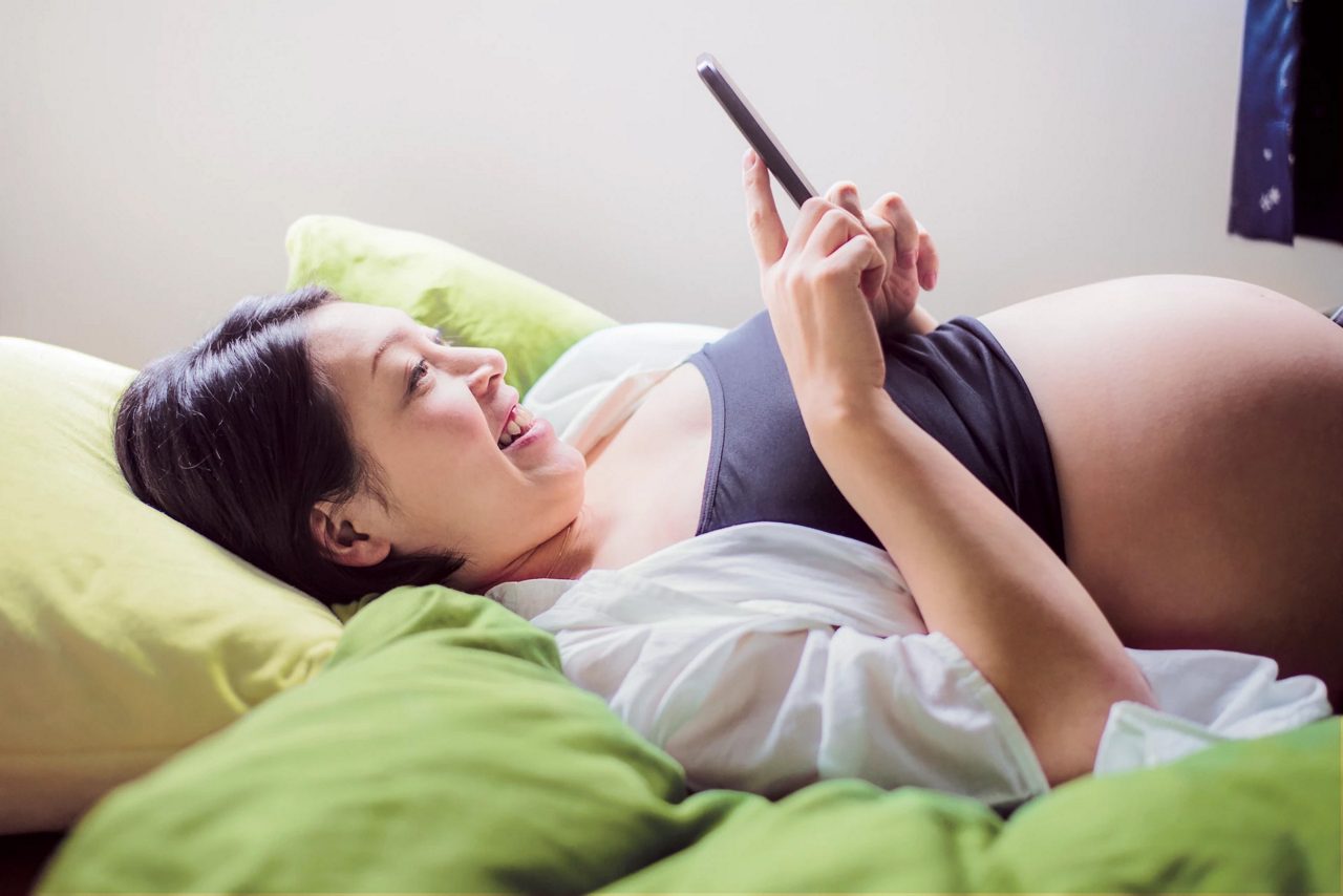 pregnant laying down on bed