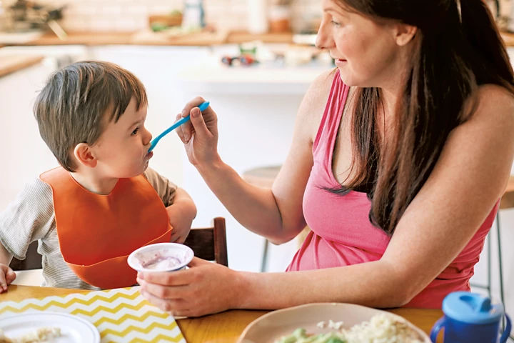 Mum feeding toddler