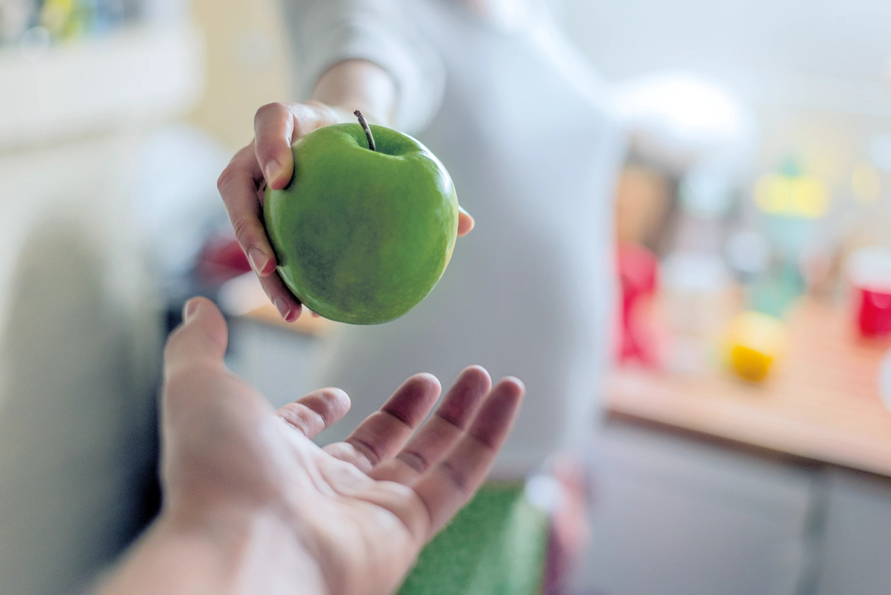 hand and apple