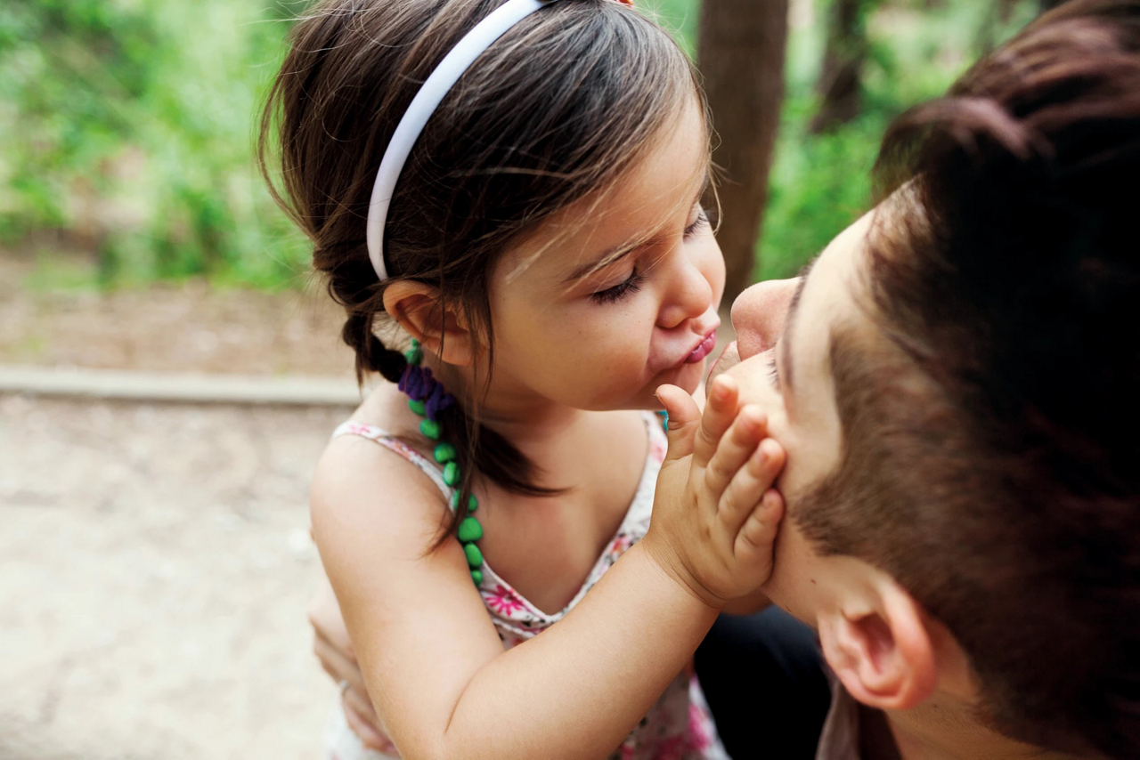 little girl kissing dad