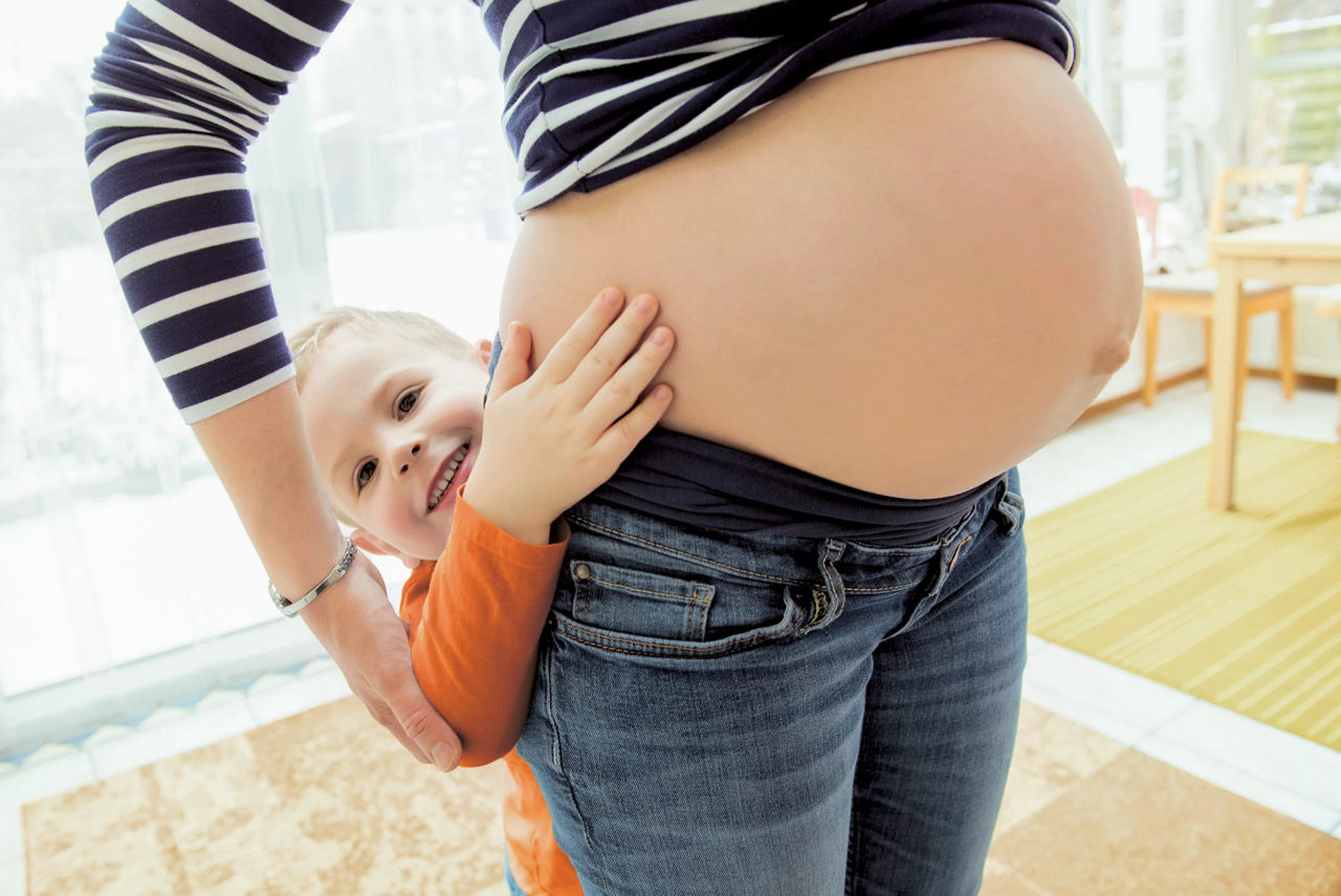 toddler hugging pregnant mom