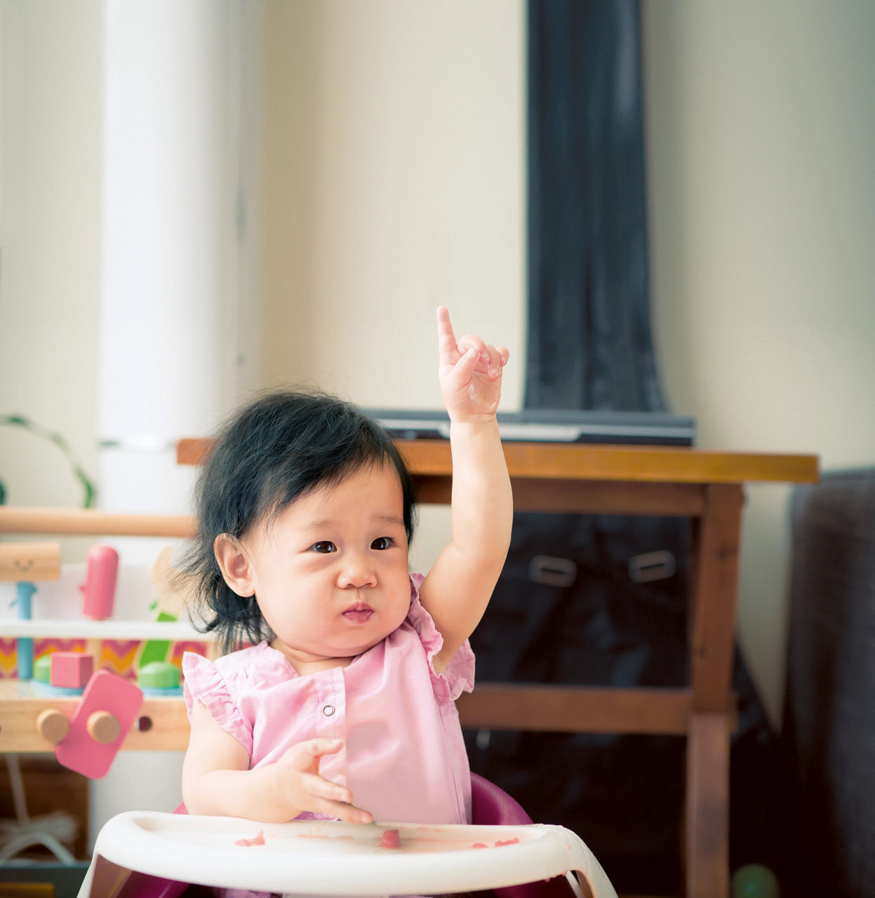 Baby rasing a hand