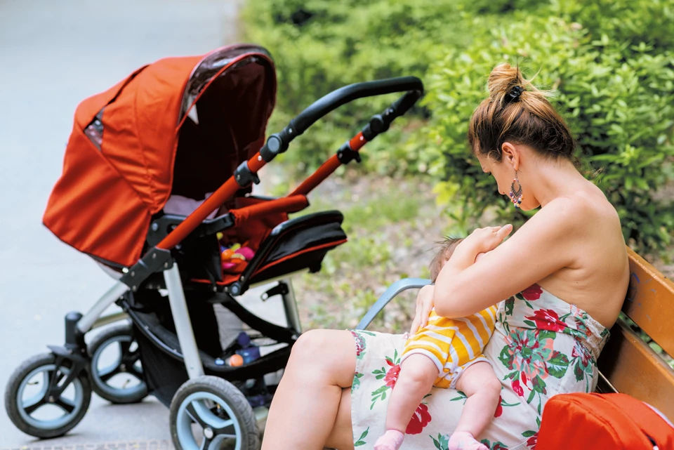 Feeding baby outside on a bench