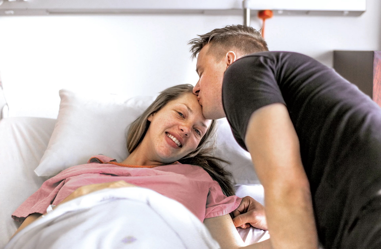 woman in hospital bed with husband