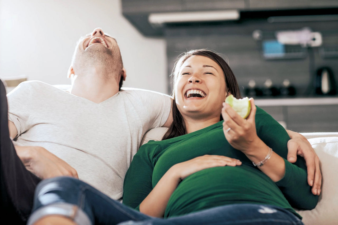 couple laughing on the sofa
