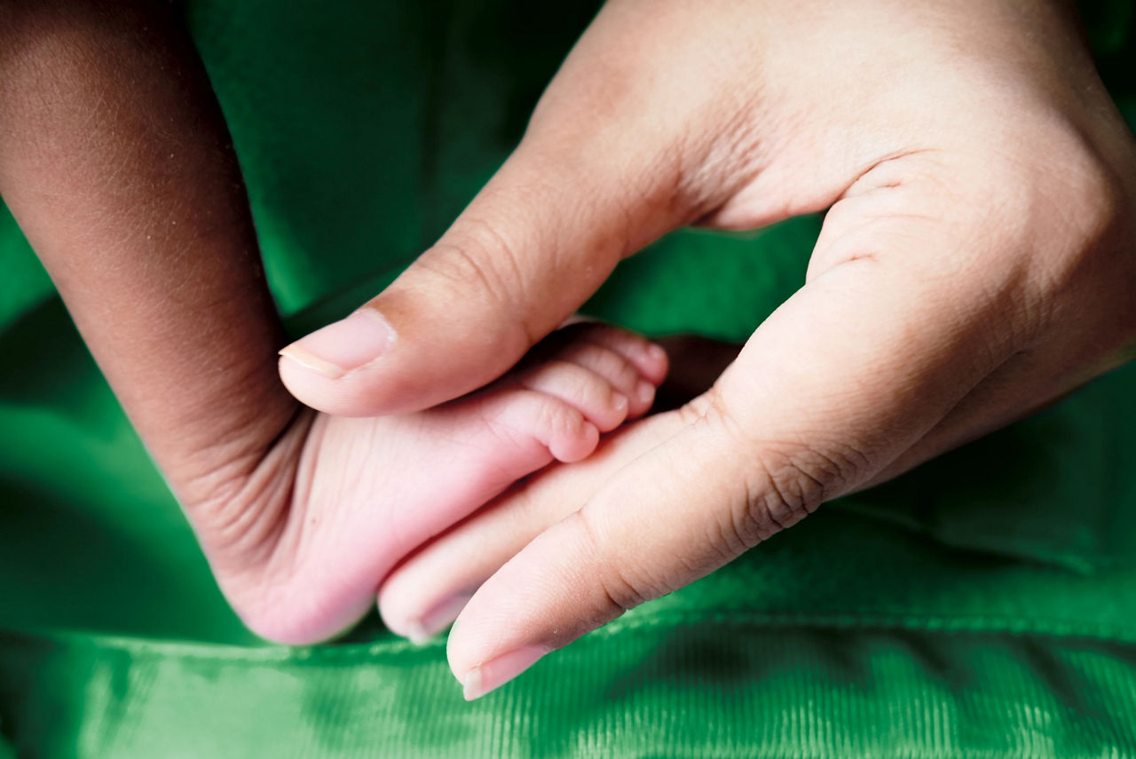 Mom holding baby's foot