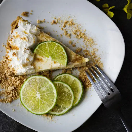 Key lime pie slice with whipped cream