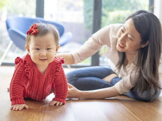 Little girl dressed in red with her mother