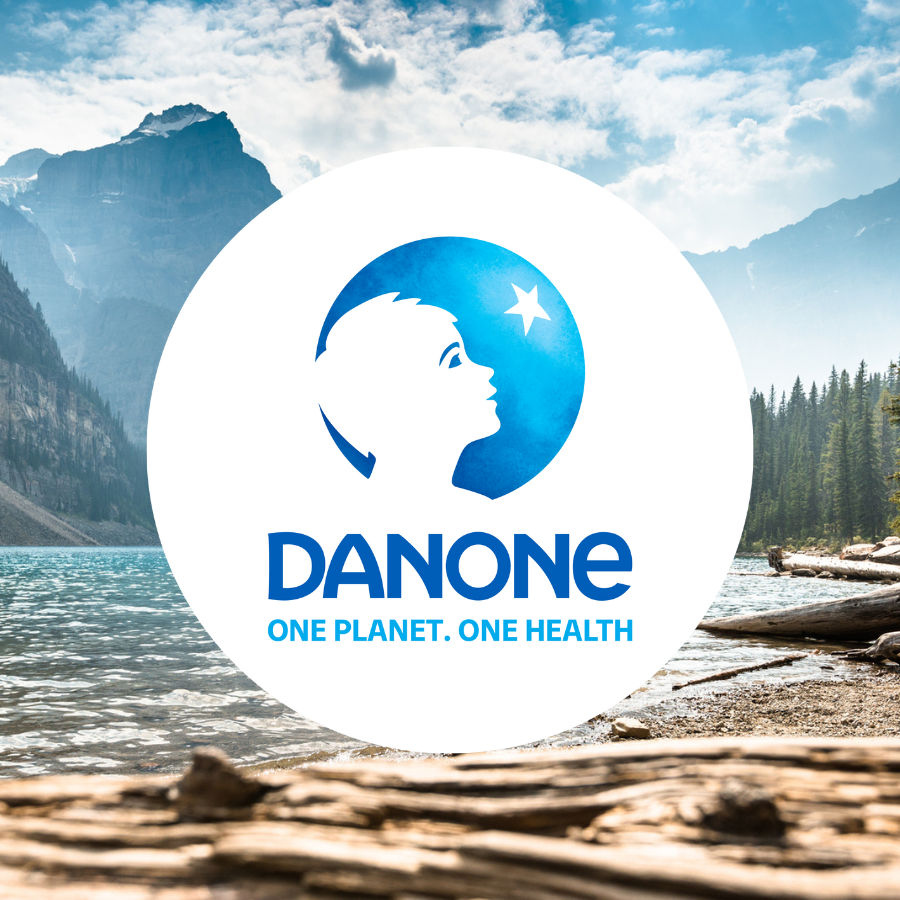 Image of a landscape featuring trees and mountains, with the Danone logo prominently displayed in blue at the forefront