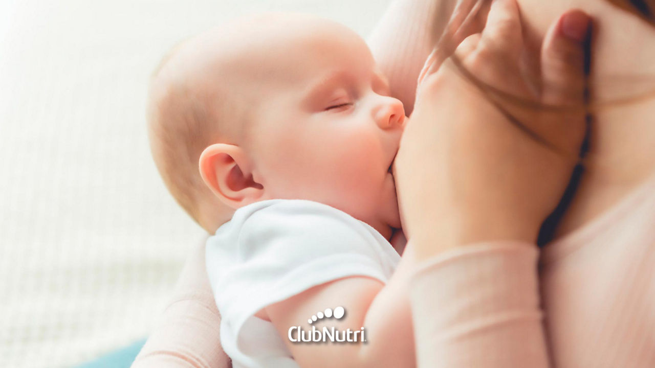 Breastfeeding baby on bed