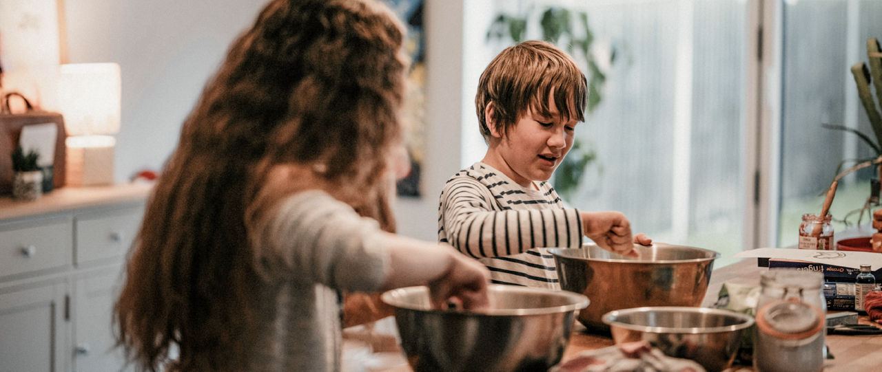 Brother and sister cooking in the kitchen