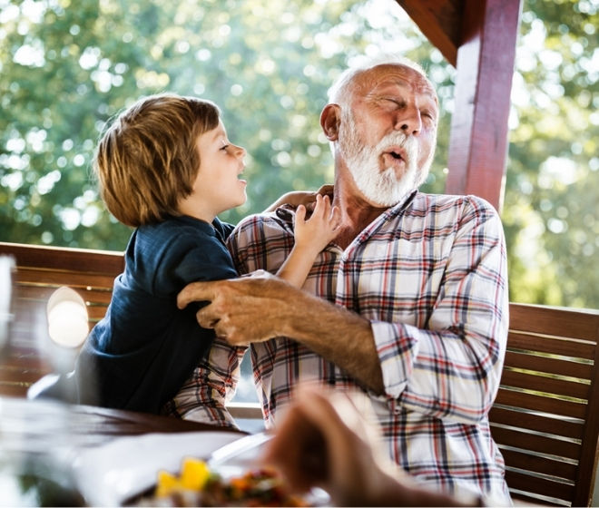 Grandfather and grandson embracing