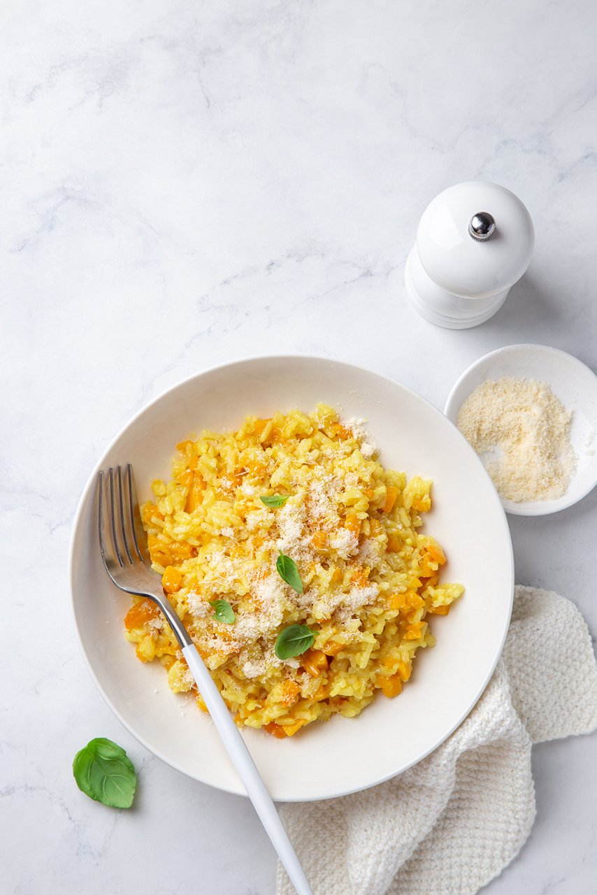 Pumpkin risotto in white bowl, top view