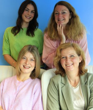 a group of three smiling dietitians standing together. They are wearing professional attire and appear to be in a welcoming and supportive environment. It also contains some informational text