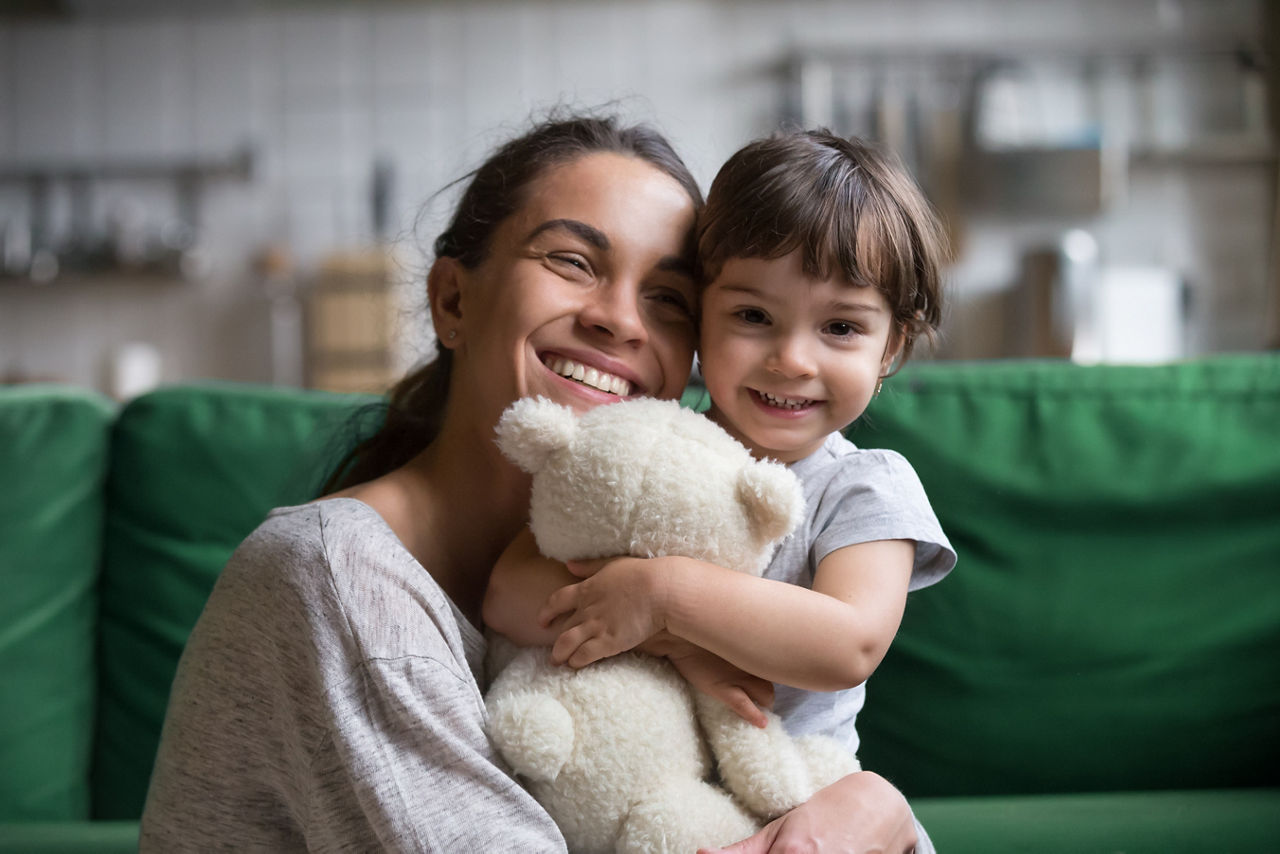 Mum cuddles toddler